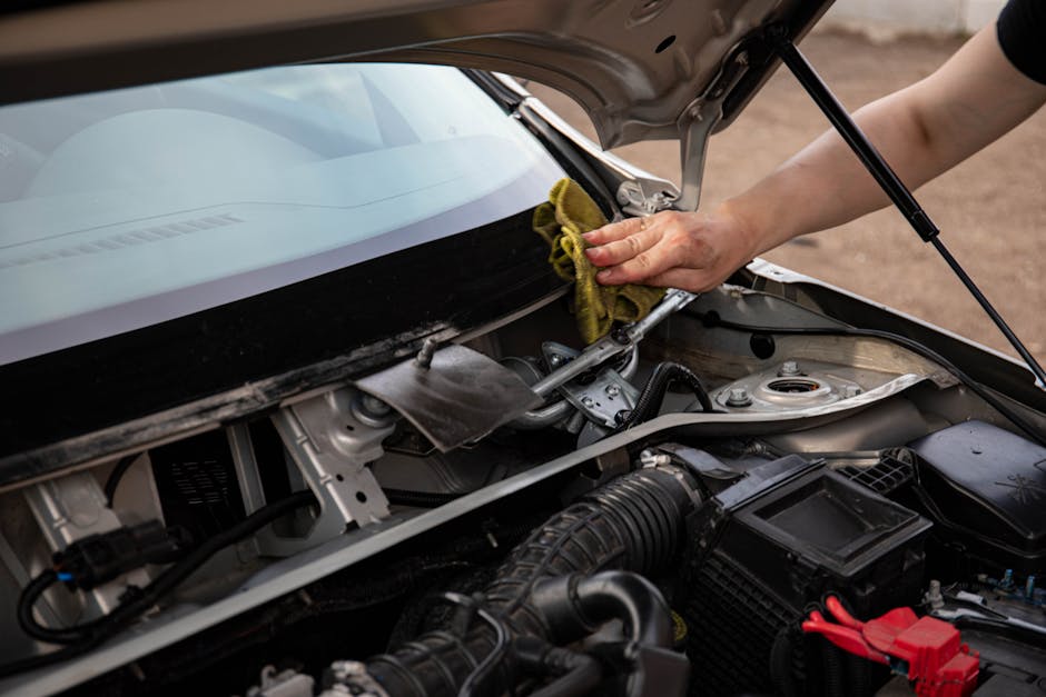 Technician performing windshield repair on a chip